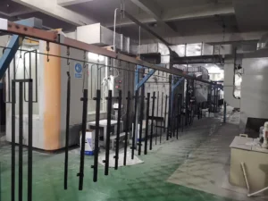 Powder Coating Line With Metal Parts Hanging For Surface Treatment In A Factory